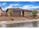 Charming single-story house with a well-manicured front yard and brick-paved driveway leading to the garage at 741 Monroe Hill Pl, Henderson, NV 89011