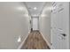 Bright hallway with wood-look flooring and white doors offering a modern and clean aesthetic at 741 Monroe Hill Pl, Henderson, NV 89011