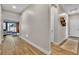 Hallway with wood-look flooring, leading to a cozy living space and offering easy access to other rooms at 741 Monroe Hill Pl, Henderson, NV 89011