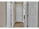 Hallway with multiple white doors leading to various rooms, offering privacy and functionality in the home at 741 Monroe Hill Pl, Henderson, NV 89011
