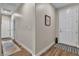 Entryway featuring wood-look flooring, a decorative 'Home Sweet Home' sign, and ample natural light at 741 Monroe Hill Pl, Henderson, NV 89011