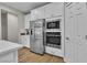 Modern kitchen featuring stainless steel appliances, white cabinets, and a built-in microwave and oven at 741 Monroe Hill Pl, Henderson, NV 89011