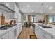 Well-appointed kitchen featuring white cabinets, subway tile backsplash, stainless steel appliances, and an island at 741 Monroe Hill Pl, Henderson, NV 89011
