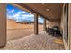 Covered patio featuring a tiled floor and an outdoor dining area overlooking the backyard at 741 Monroe Hill Pl, Henderson, NV 89011