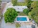 Expansive backyard oasis featuring a refreshing swimming pool, lush greenery, and mature trees providing ample shade at 7545 Constantinople Ave, Las Vegas, NV 89129