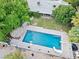 Aerial view of the in-ground pool with a slide, diving board, tiki hut and outdoor seating area at 7545 Constantinople Ave, Las Vegas, NV 89129