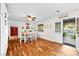 Charming dining area with wood floors, flowing into a kitchen with white cabinets and natural light at 7545 Constantinople Ave, Las Vegas, NV 89129