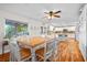 Bright dining area with a wood table, white chairs, and seamless flow into the kitchen at 7545 Constantinople Ave, Las Vegas, NV 89129