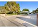 Expansive driveway leading to a charming ranch-style home with mature landscaping, offering ample parking at 7545 Constantinople Ave, Las Vegas, NV 89129