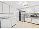 Bright laundry area featuring a washer and dryer, and built in cabinets with stainless steel refrigerator at 7545 Constantinople Ave, Las Vegas, NV 89129