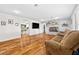 Cozy living room featuring hardwood floors, a brick fireplace, and comfortable seating at 7545 Constantinople Ave, Las Vegas, NV 89129