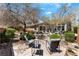 Outdoor seating area with lounge furniture, mature trees, and private landscaping at 7567 Desertscape Ave, Las Vegas, NV 89178
