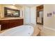 Luxurious bathroom featuring a soaking tub, walk-in shower, and dual sinks at 7567 Desertscape Ave, Las Vegas, NV 89178