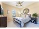 Bright bedroom with a ceiling fan, neutral paint and carpet, and ample natural light at 7567 Desertscape Ave, Las Vegas, NV 89178