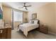 Cozy bedroom featuring a ceiling fan, neutral walls, and a comfortable-looking bed at 7567 Desertscape Ave, Las Vegas, NV 89178