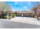 Charming exterior featuring a three-car garage, mature landscaping, and a wide driveway at 7567 Desertscape Ave, Las Vegas, NV 89178