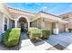 Charming home featuring mature landscaping, two-car garage, and covered entryway at 7567 Desertscape Ave, Las Vegas, NV 89178