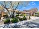 Traditional home with a well-manicured lawn, mature landscaping and three-car garage at 7567 Desertscape Ave, Las Vegas, NV 89178