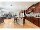 Open concept kitchen with dark wood cabinets, granite countertops, and stainless steel appliances at 7567 Desertscape Ave, Las Vegas, NV 89178