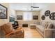 Cozy living room features hardwood floors, neutral colors, and a comfortable sectional couch at 7567 Desertscape Ave, Las Vegas, NV 89178
