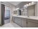En-suite bathroom featuring double sinks, large mirror, and modern vanity at 7572 Mount Spokane Ct, Las Vegas, NV 89113