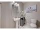 Powder room featuring pedestal sink, modern fixtures, and decorative accents at 7572 Mount Spokane Ct, Las Vegas, NV 89113