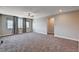 Large bonus room with plush carpeting, natural light, and a ceiling fan at 7572 Mount Spokane Ct, Las Vegas, NV 89113