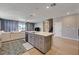 Open kitchen view featuring an island and adjoining living area with natural light at 7572 Mount Spokane Ct, Las Vegas, NV 89113