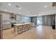 Open-concept kitchen featuring a large center island with seating, modern appliances, and seamless flow to the living area at 7572 Mount Spokane Ct, Las Vegas, NV 89113