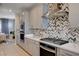 Close-up of the kitchen featuring stainless steel range hood and modern appliances at 7572 Mount Spokane Ct, Las Vegas, NV 89113