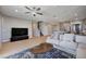 Spacious living room with a comfortable couch, a modern coffee table, and an open flow to the kitchen at 7572 Mount Spokane Ct, Las Vegas, NV 89113