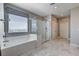 Bathroom featuring a modern soaking tub and a walk-in shower with glass door at 7572 Mount Spokane Ct, Las Vegas, NV 89113