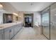 Main bathroom featuring double vanity, walk-in shower, and neutral decor at 7572 Mount Spokane Ct, Las Vegas, NV 89113