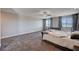 Main bedroom features plush carpet, ceiling fan, and large windows at 7572 Mount Spokane Ct, Las Vegas, NV 89113