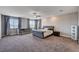 Spacious main bedroom featuring neutral decor, carpet, ceiling fan, and natural light at 7572 Mount Spokane Ct, Las Vegas, NV 89113