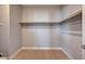 Empty walk-in closet space with wood flooring, rod and shelf storage system at 7572 Mount Spokane Ct, Las Vegas, NV 89113