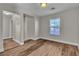 A bright, empty bedroom with wood-look floors and a window at 7632 Calico Fields St, Las Vegas, NV 89149