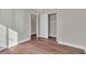 Bedroom with wood floors, a closet featuring an open door, and freshly painted walls at 7632 Calico Fields St, Las Vegas, NV 89149