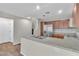 Modern kitchen with stainless steel appliances, granite countertops, and stairs to the second floor at 7632 Calico Fields St, Las Vegas, NV 89149