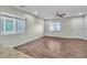 Spacious living room featuring wood-look tile and natural light through two large windows at 7632 Calico Fields St, Las Vegas, NV 89149