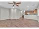 A bright and airy living room with wood-look tile flooring and a ceiling fan at 7632 Calico Fields St, Las Vegas, NV 89149