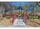 This is a colorful playground featuring trees and a grassy area at 7632 Calico Fields St, Las Vegas, NV 89149