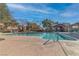 Community pool with clear blue water, surrounded by lounge chairs and greenery, ideal for summer relaxation at 7632 Calico Fields St, Las Vegas, NV 89149