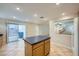 Open kitchen with a kitchen island, stainless steel sink, tiled floor, and sliding glass door access to the back patio at 765 Jewel Tower St, Las Vegas, NV 89178