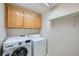 Laundry room featuring wood cabinets, shelving, and a washer and dryer at 765 Jewel Tower St, Las Vegas, NV 89178