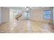 Expansive living room boasts tile flooring and a naturally lit staircase to the second story at 765 Jewel Tower St, Las Vegas, NV 89178