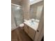 Bathroom featuring a glass-enclosed shower, a toilet, and a single sink vanity at 7969 Cina Ave, Las Vegas, NV 89147