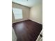 Cozy bedroom with a bright window, smooth walls, and dark flooring creating a warm and inviting atmosphere at 7969 Cina Ave, Las Vegas, NV 89147