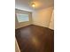 A bedroom with neutral walls and dark wood flooring that gets lots of light from the window at 7969 Cina Ave, Las Vegas, NV 89147