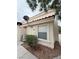 Exterior shot of the townhome, showing the side and some landscaping at 7969 Cina Ave, Las Vegas, NV 89147